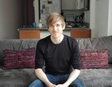 Steve Dean '11 sitting on a couch